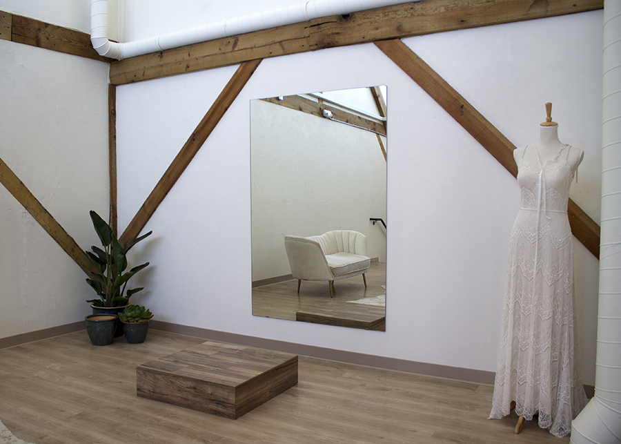 a view of the large private viewing studio, minimal design aspects utilizing natural materials allows the dresses to standout
